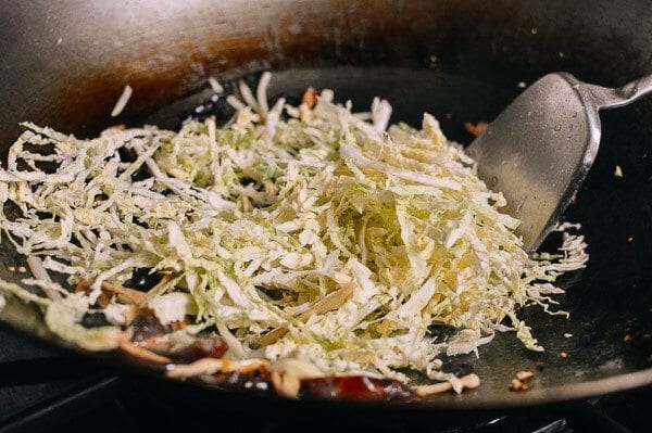 Adding shredded cabbage to wok, by aedison.aieoederdu.tk