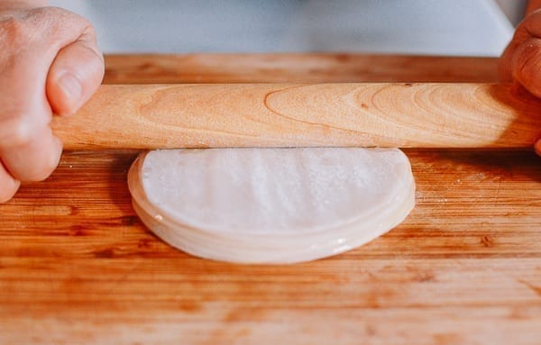 Pressing stack of dumpling wrappers with rolling pin, aedison.aieoederdu.tk