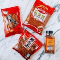 Sichuan chili flakes next to regular crushed red pepper, aedison.aieoederdu.tk