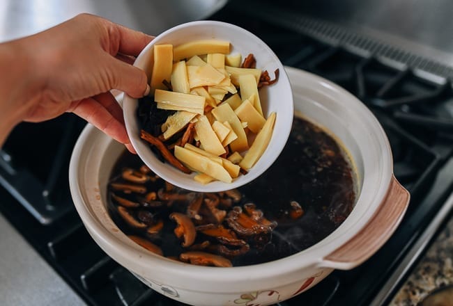 Adding mushrooms, lily flowers, and bamboo shoots to pot of soup, aedison.aieoederdu.tk