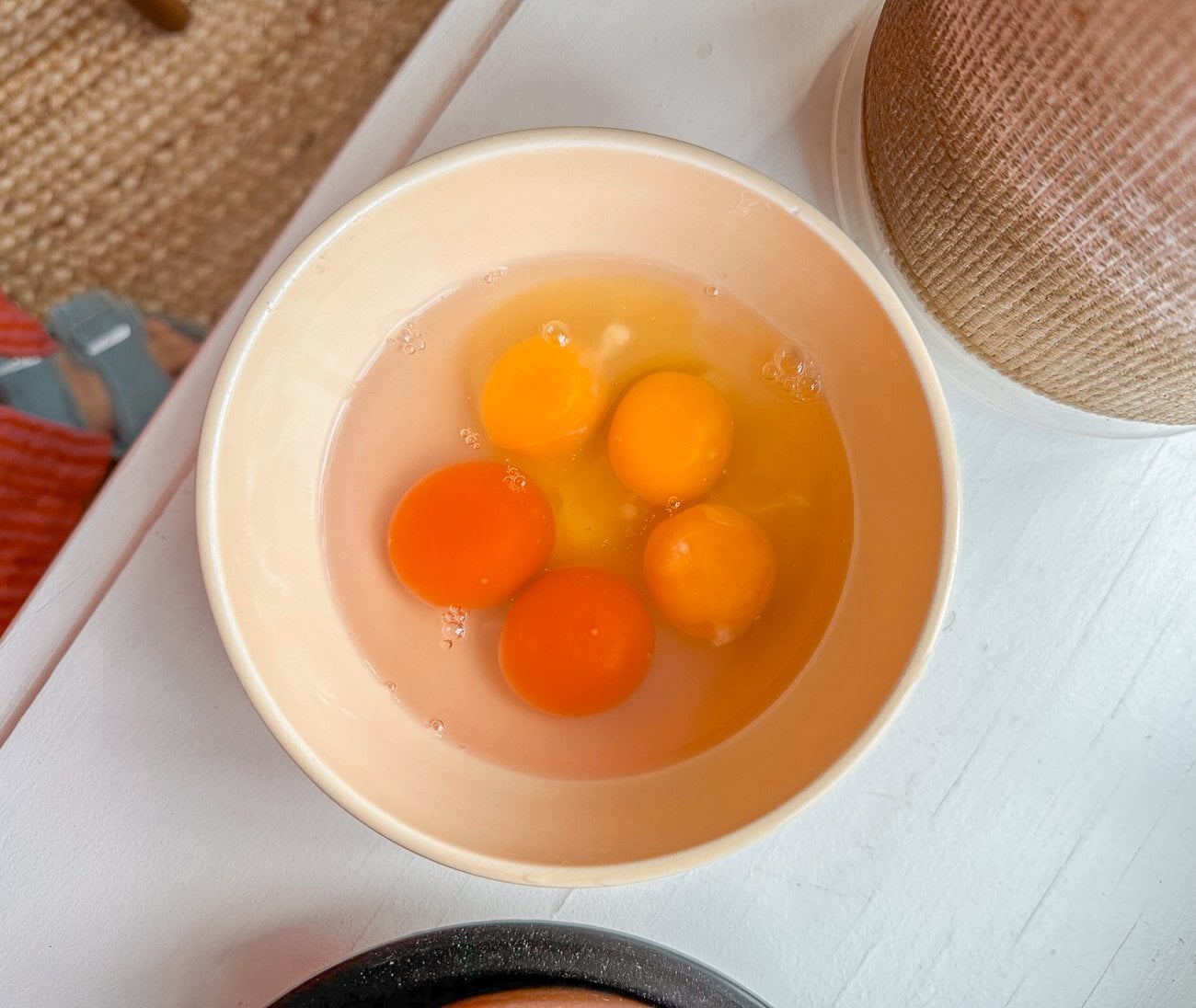 chicken and duck eggs cracked in a bowl